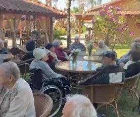 Residentes almoçando no jardim